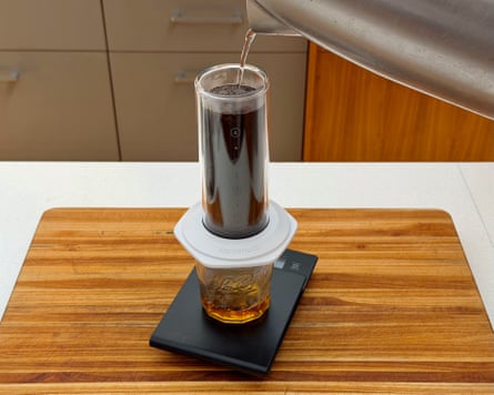 A person making coffee with an aeropress premium