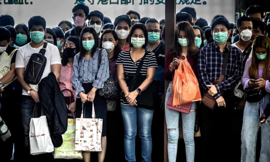 THAILAND-CHINA-HEALTH-VIRUSCommuters with protective face masks wait to board a canal boat in the Thai capital, Bangkok.