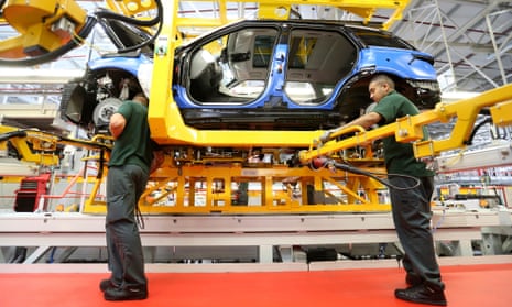Employees work on a Jaguar Land Rover production line