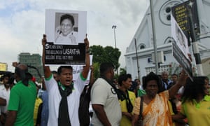 A protester holds a portrait of Lasantha Wickrematunge, who was assassinated by gunmen on motorcyles as he went to work in Colombo, Sri Lanka.