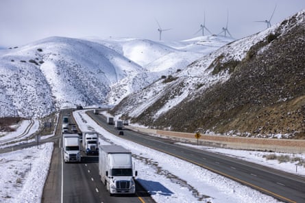 Truckers drive across the southern Sierra Nevada mountains following a pass’s reopening near Mojave, California.