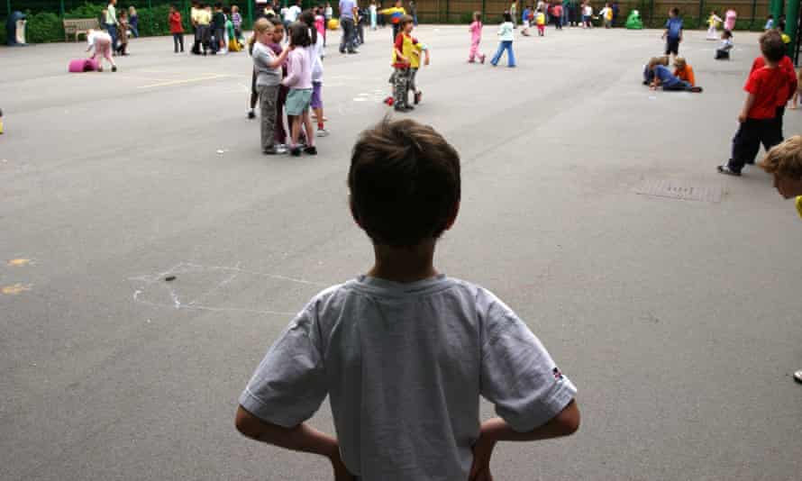 A child alone in a school playground.