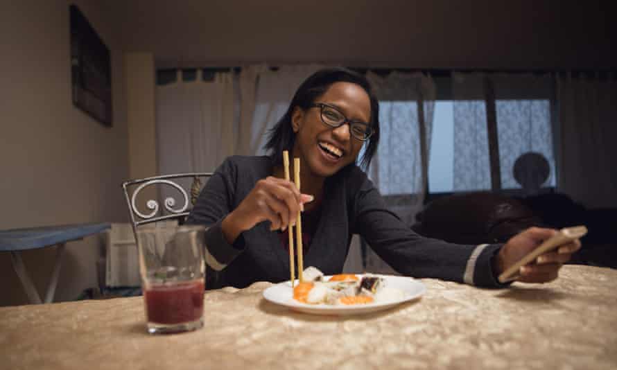 Christine Odunlami has a takeout sushi dinner at her home in Toronto, Canada.