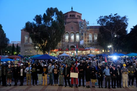Pro-Palestinian demonstrators raise weapons on UCLA campus.