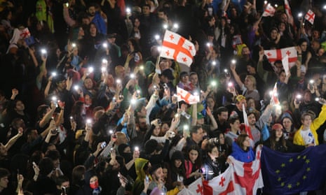 Protestors, gathered in front of the parliament building, block the main roads as they march within a protest against the bill on 'Transparency of Foreign Influence,' in Tbilisi.