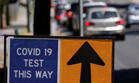 A COVID-19 Test sign is seen on Elgar Road as members of the public are seen queuing in their cars at a drive-through COVID-19 testing site at Deakin University Burwood Campus, Burwood in Melbourne