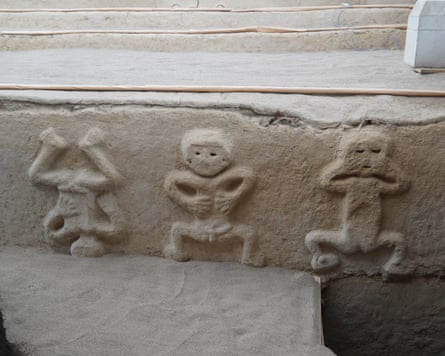 A frieze depicting three humanised toads doing a ritual dance.