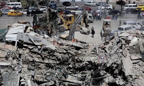 Rescue workers search the rubble of a building annexed to the Iranian embassy on 2 April after an airstrike in Damascus, Syria.