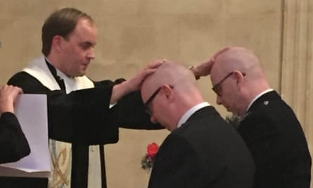 The Rev Joost Röselaers lays his hands on John and John during their marriage ceremony