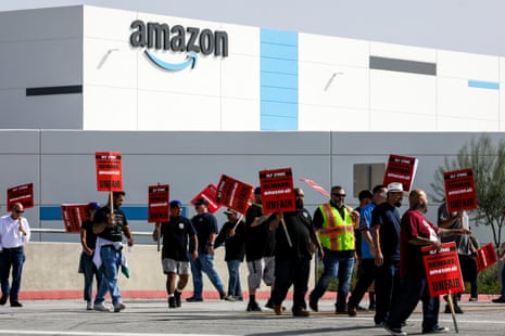 people protest outside an Amazon facility