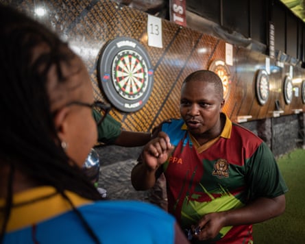 Benard Muiruri speaks with teammate Victoria Wangu.