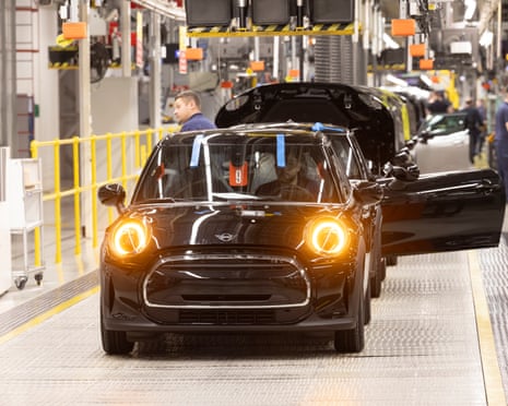 Mini cars being check on the assembly line at the plant, owned by BMW, in Oxford.