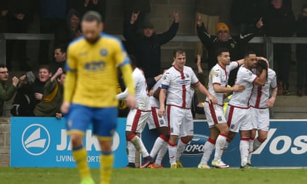Dean Beckwith is congratulated after scoring Sutton’s winner at Torquay.