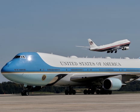 One huge plane in foreground, with similarly huge plane taking off beyond it.