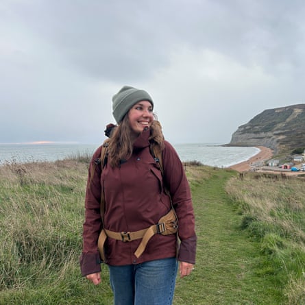 Writer testing the Klättermusen Allgron 2.0 women’s waterproof jacket outdoors by the UK seaside on a grey day.