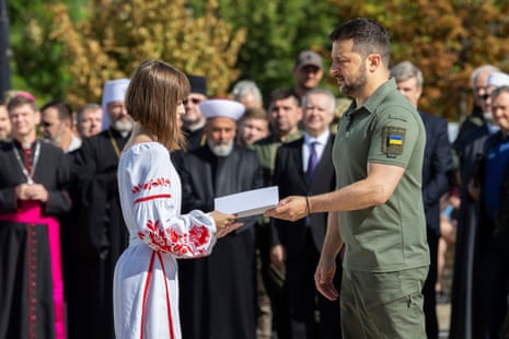 Volodymyr Zelenskiy hands over a passport in Kyiv