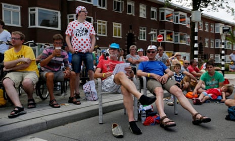 Spectators watch the riders on the big screen in Utrecht.