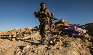 Fighters with the Syrian Democratic Forces (SDF) keep position at a hilltop overlooking Isis in the village of Baghuz on 18 March 2019. 3072.jpg?width=300&quality=85&auto=forma