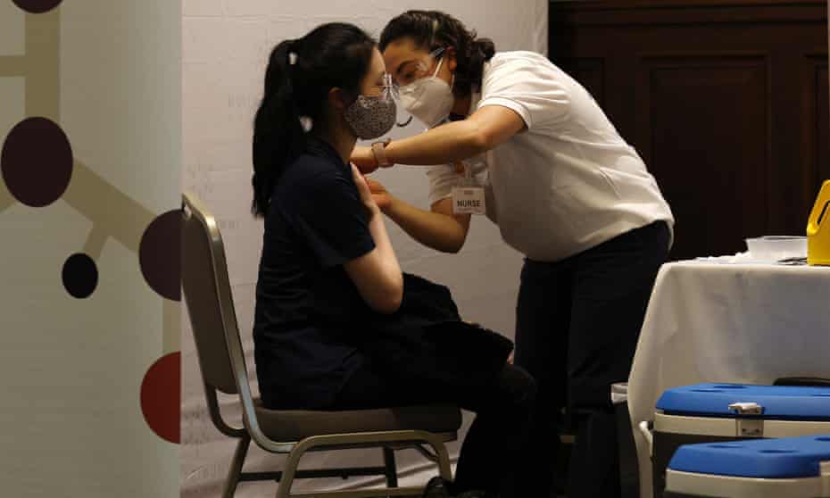 A woman receives a free flu vaccination