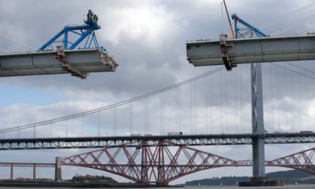 Work is carried out on the central sections of  Queensferry Crossing, with the old Forth road and Forth railway bridges in the background.