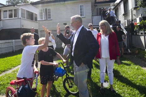 Labor leader Anthony Albanese greets local kids as he inspects a street affected by recent flooding events in the suburb of Auchenflower in Brisbane.