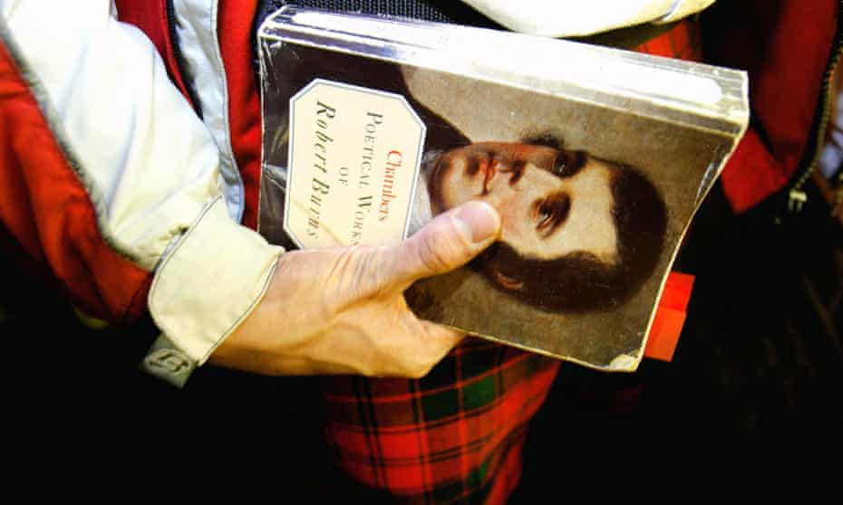 a tartan-clad man holds a collection of Robert Burns’s poetry.