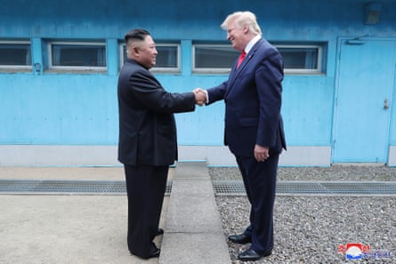 Kim Jong-un and Donald Trump shake hands on the border in the truce village of Panmunjom in the Demilitarized Zone in June 2019.