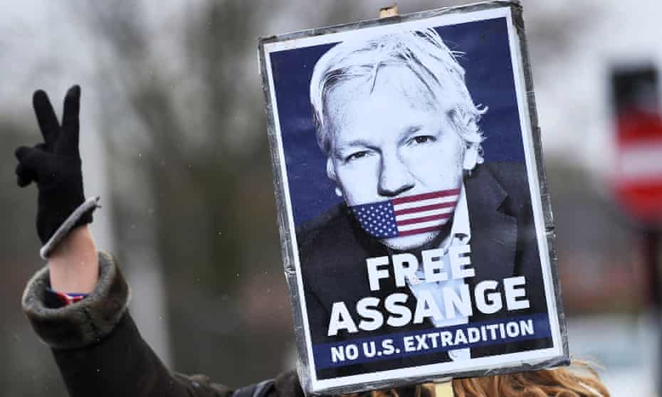 Protester with Free Assange poster