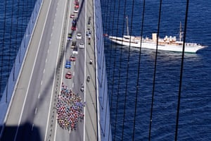 The Danish Royal Yacht “Dannebrog” sails by as the peloton crosses the Great Belt Bridge