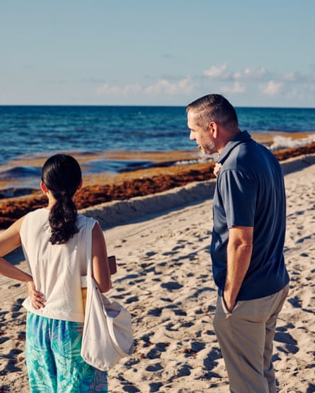 two people standing on a beach