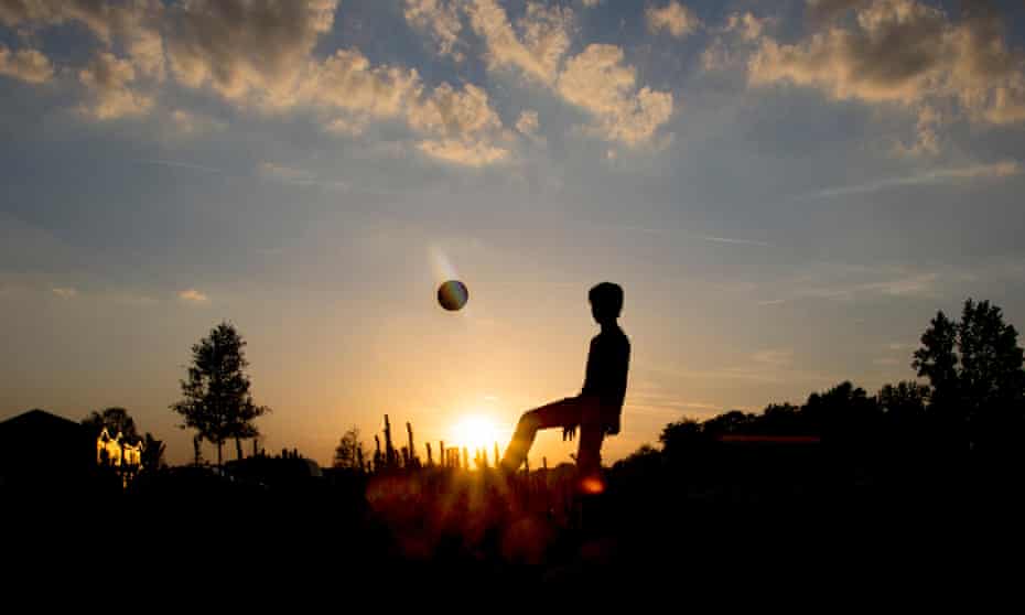 A teenage boy playing football