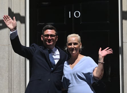 Andy Burnham and his wife, Marie-France van Heel, wave on the steps of 10 Downing Street.