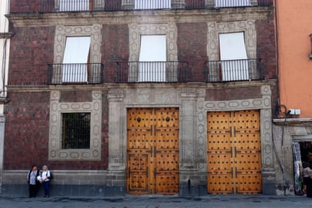 Building facade with wonky-looking windows and doorframes