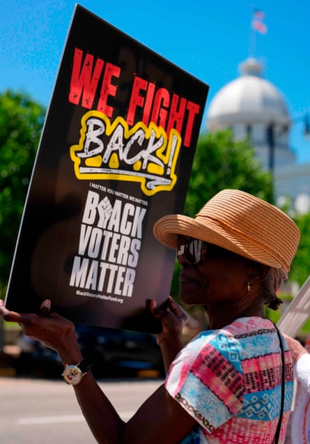 a woman carrying a sign