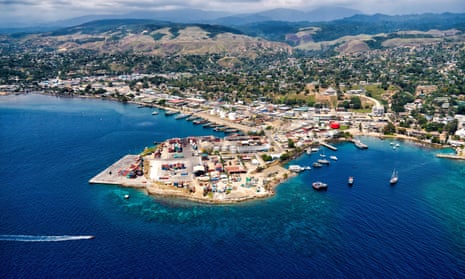 Aerial photo of Solomon Islands industrial port featuring ships and clear, blue water