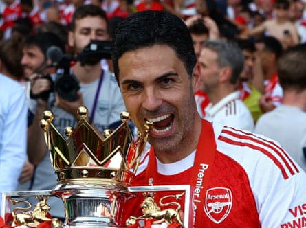 Arsenal manager Mikel Arteta celebrates with the trophy after winning the Premier League