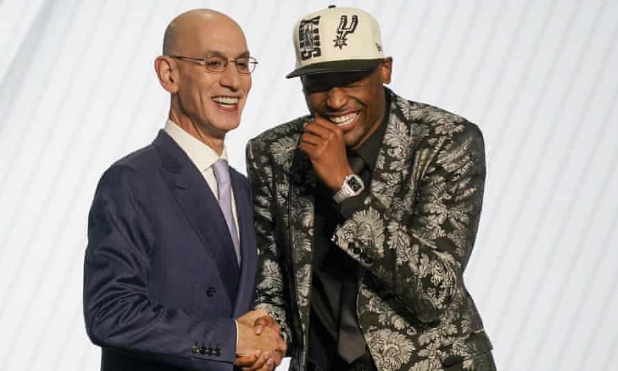 Malaki Branham shares a laugh with Adam Silver after his selection
