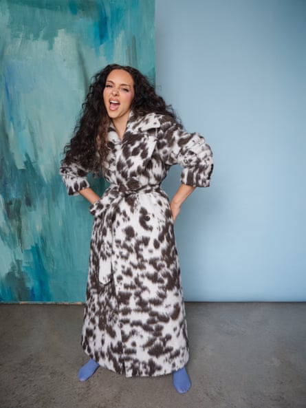 Jade Thirlwall wearing a long, animal-print coat and blue tights