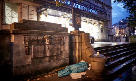 A homeless person sleeping outside a luxury hotel in Liverpool.