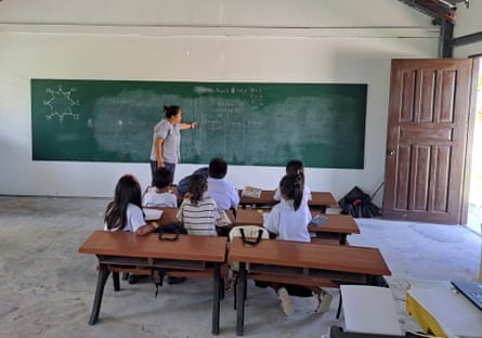Realyn Limbo stands in front of a blackboard