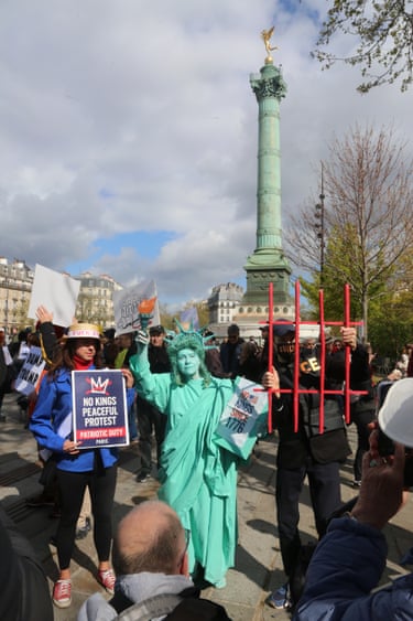 ParisUS expats, including a woman dressed as the Statue of Liberty – which was a gift to the US from France – gather at the Place de la Bastille.