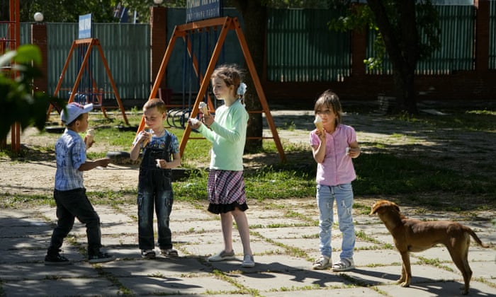 Children eat ice cream at a park in the city of Kherson, in southern Ukraine.