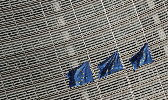 European Union flags flutter outside the European Commission headquarters in Brussels, Belgium.