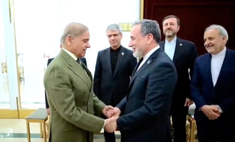 Iranian foreign minister Abbas Araqchi shakes hands with Pakistani prime minister Shehbaz Sharif.