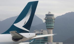 A Cathay Pacific jet is seen in front of air traffic control tower at the Hong Kong International Airport.