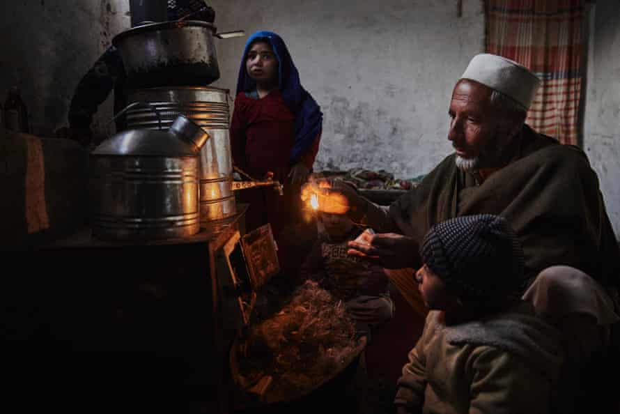 Gul Khan* prepares to light the stove using shredded plastic as fuel in the family’s home in Kabul.
