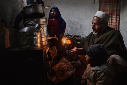 Gul Khan* prepares to light the stove using shredded plastic as fuel in the family’s home in Kabul.