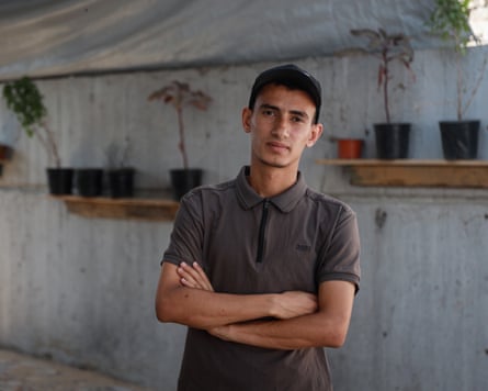 A young Palestinian man standing with his arms folded