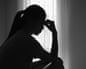 Silhouette of distressed woman.