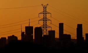 A high voltage electricity transmission tower is seen in the foreground of the Brisbane CBD skyline